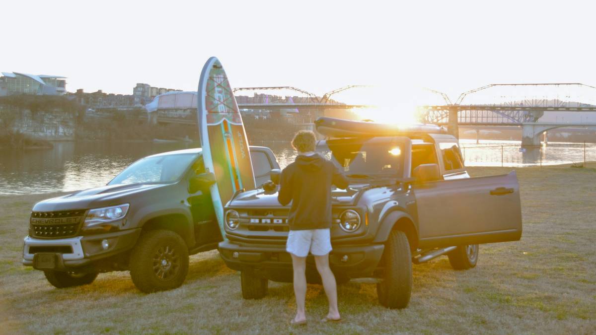 Close-up of surfboard secured in truck bed with proper tie-down placement